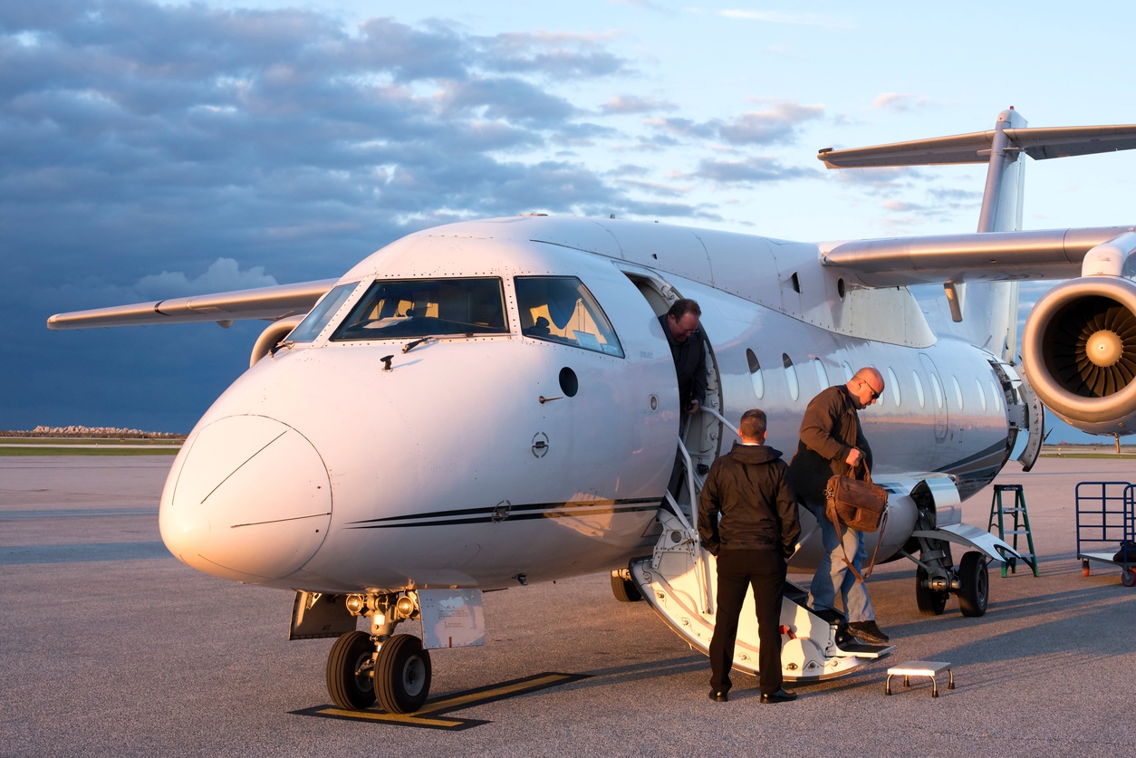 business people leaving plane